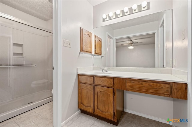 2209 Winchester Dr, Temple, TX 76502 - full bath with vanity, ceiling fan, tile patterned flooring, a shower stall, and a textured ceiling