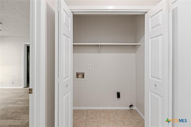 2209 Winchester Dr, Temple, TX 76502 - laundry area featuring washer hookup, hookup for an electric dryer, and light tile patterned flooring
