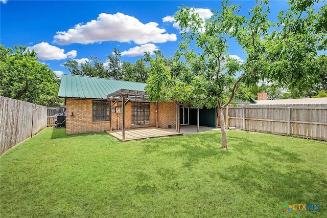 2209 Winchester Dr, Temple, TX 76502 - back of house with brick siding, a fenced backyard, a patio, a metal roof, and a standing seam roof