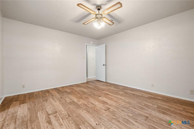 2209 Winchester Dr, Temple, TX 76502 - empty room with a ceiling fan, light wood-style flooring, and a textured ceiling