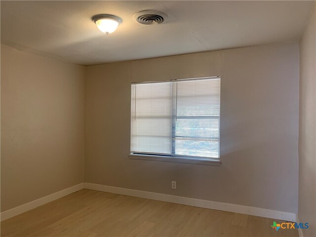 unfurnished room with light wood-type flooring