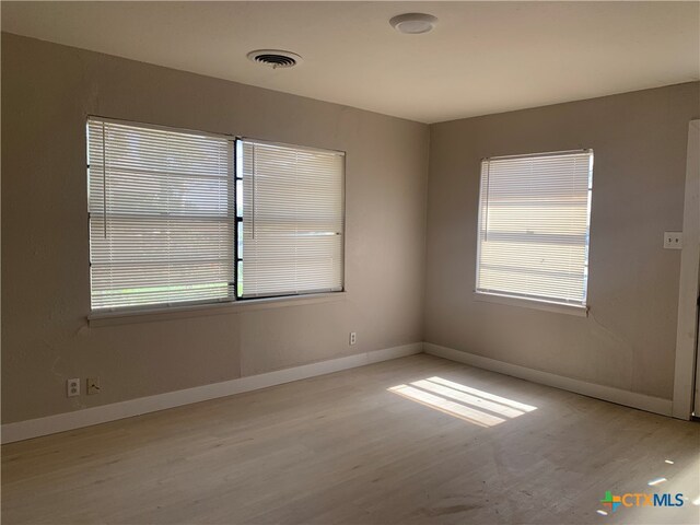 empty room with light hardwood / wood-style flooring