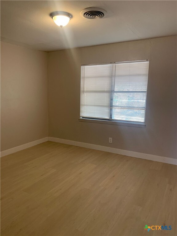 unfurnished room featuring light wood-type flooring