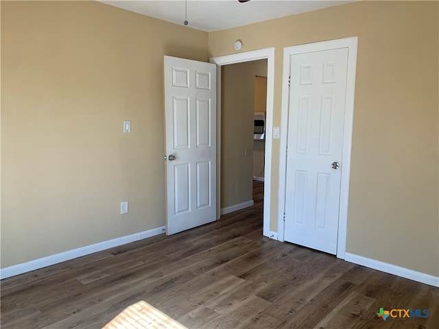 unfurnished bedroom featuring dark wood-type flooring