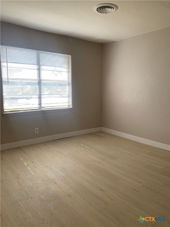 unfurnished room featuring light hardwood / wood-style flooring