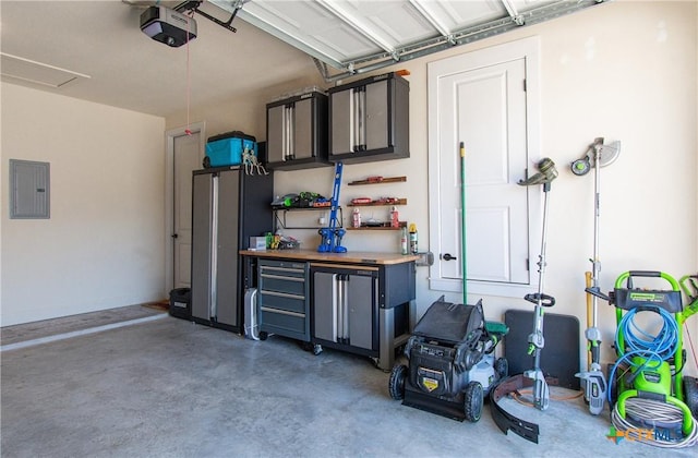 garage with electric panel and a garage door opener