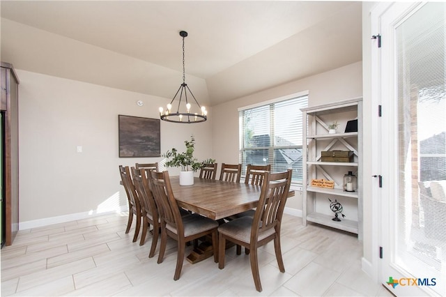 dining room with lofted ceiling and a notable chandelier