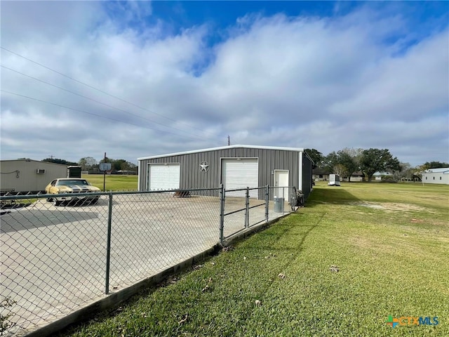 view of side of home with a yard, a garage, and an outdoor structure