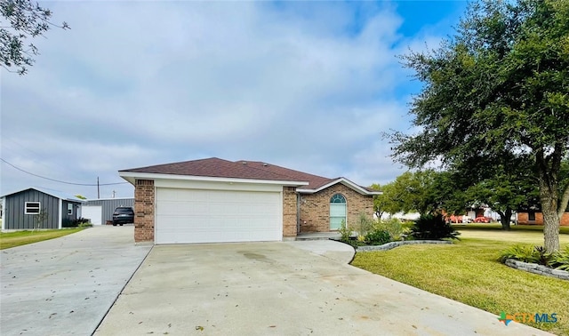 ranch-style house featuring a garage and a front lawn