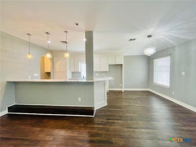 kitchen with white cabinets, decorative light fixtures, dark hardwood / wood-style floors, and lofted ceiling