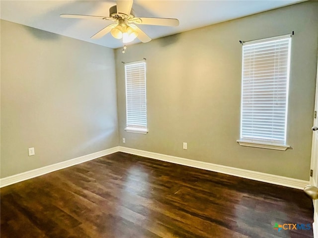 empty room featuring ceiling fan and dark wood-type flooring