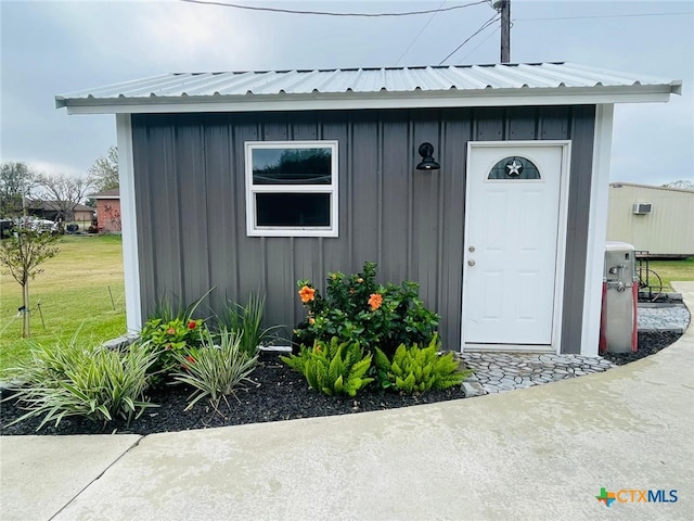 doorway to property with a yard