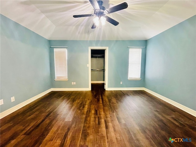 unfurnished bedroom with dark hardwood / wood-style flooring, a closet, ceiling fan, and lofted ceiling