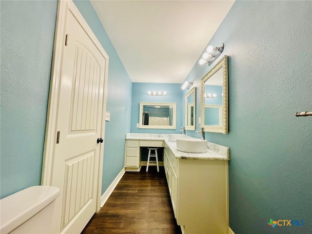 bathroom featuring hardwood / wood-style floors, vanity, and toilet