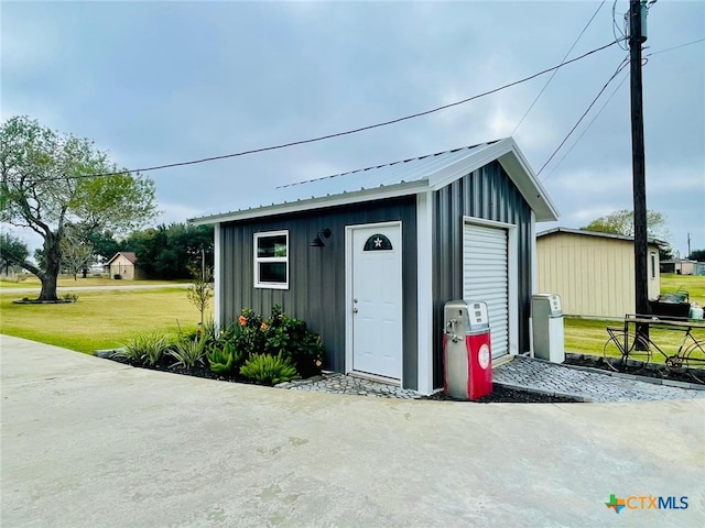 view of outbuilding with a yard