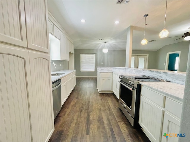 kitchen featuring appliances with stainless steel finishes, sink, pendant lighting, dark hardwood / wood-style floors, and white cabinetry