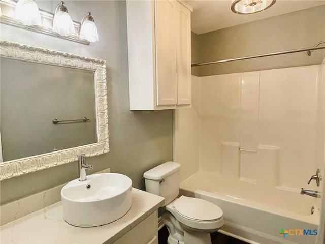 full bathroom with vanity, shower / bathtub combination, and toilet