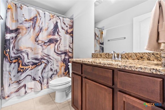 bathroom with vanity, tile patterned floors, toilet, and shower / bath combo with shower curtain