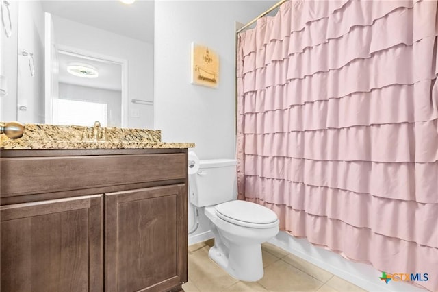 bathroom featuring shower / bath combo with shower curtain, toilet, vanity, and tile patterned flooring