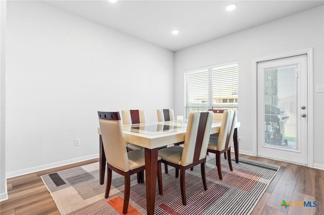 dining room with recessed lighting, baseboards, and wood finished floors