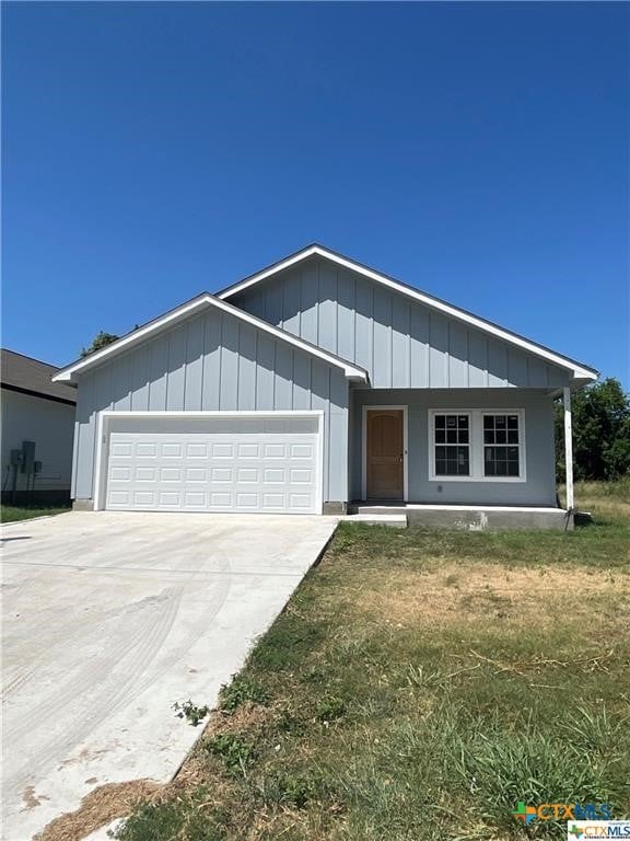 single story home featuring an attached garage and driveway