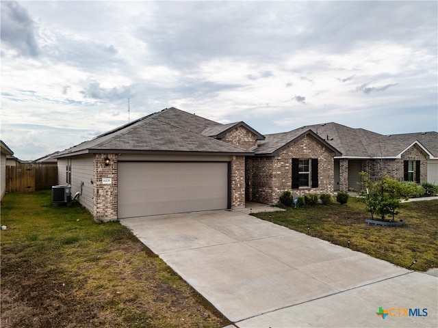 view of front of house with a front lawn, a garage, and cooling unit