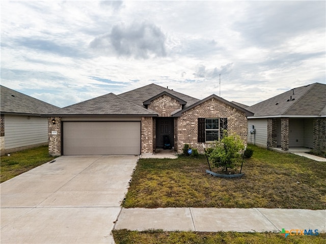 ranch-style home with a garage and a front lawn