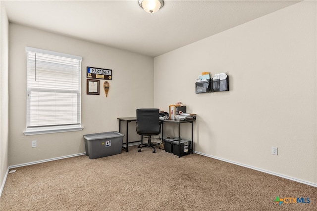 home office featuring a wealth of natural light and carpet flooring