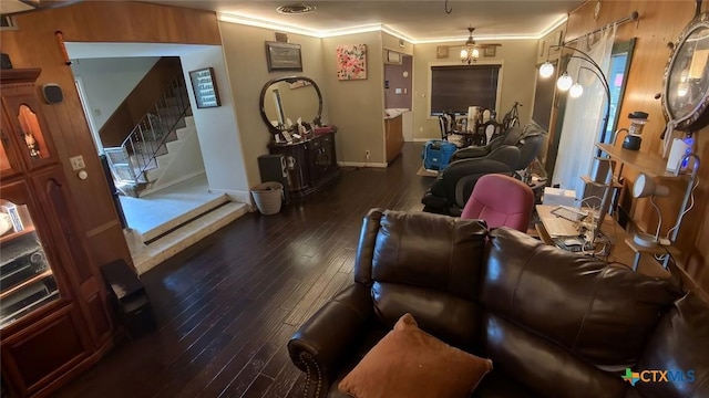 living room featuring dark wood-type flooring and crown molding