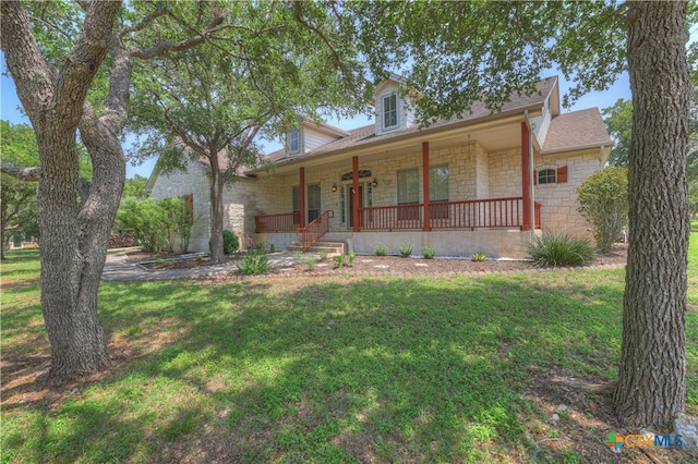 view of front of property with a porch and a front lawn