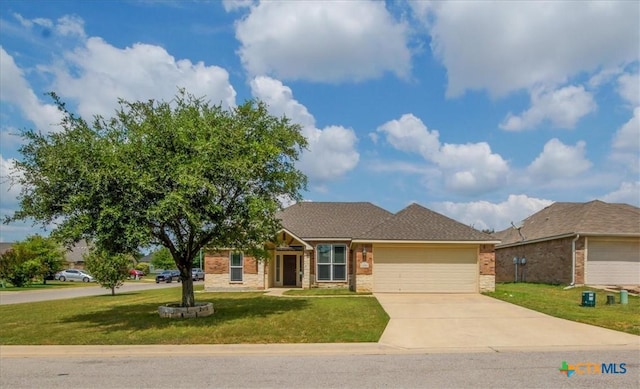 ranch-style house with brick siding, roof with shingles, a front yard, a garage, and driveway