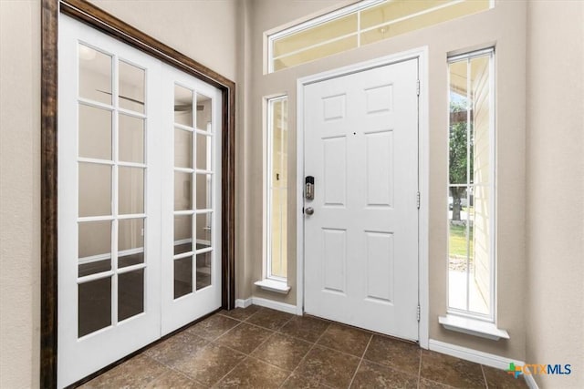 1220 Neuberry Cliffe, Temple, TX 76502 - foyer entrance with plenty of natural light, baseboards, and dark tile patterned flooring