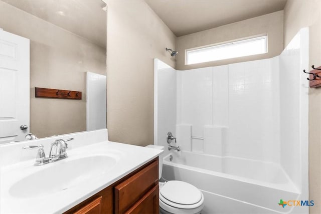 bathroom with toilet, shower / tub combination, and vanity