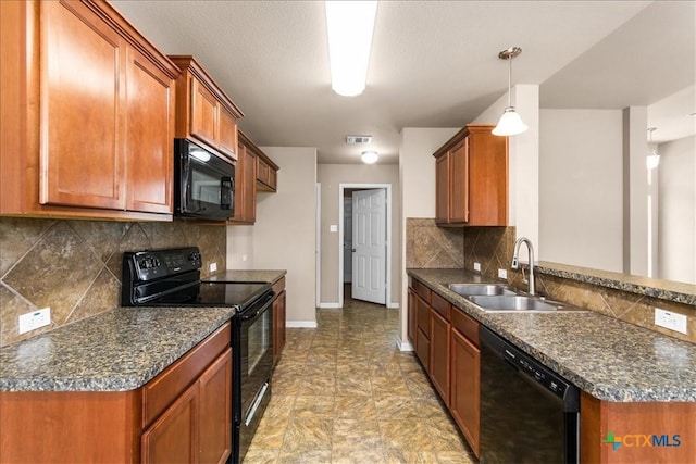 kitchen featuring visible vents, brown cabinets, decorative light fixtures, black appliances, and a sink