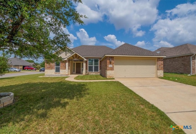 view of front of property featuring stone siding, a front yard, concrete driveway, and an attached garage