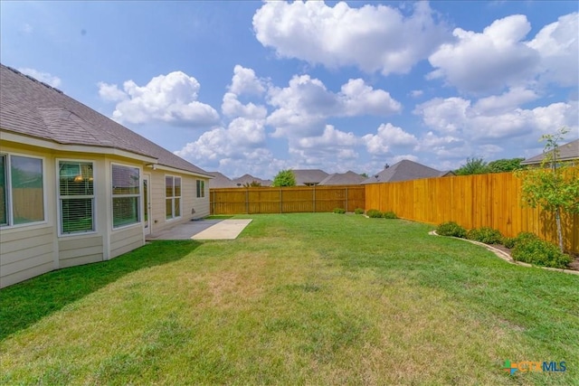 view of yard with a fenced backyard and a patio