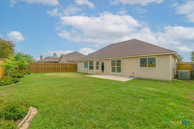 rear view of house with a fenced backyard, a patio, and a yard