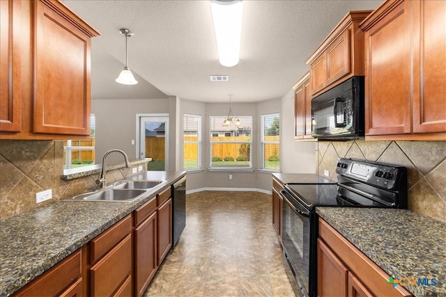 kitchen with black appliances, pendant lighting, a sink, and brown cabinetry