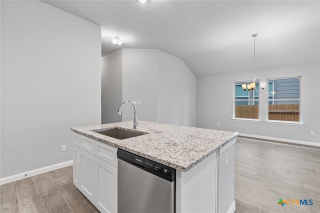 kitchen with pendant lighting, dishwasher, sink, white cabinets, and a center island with sink