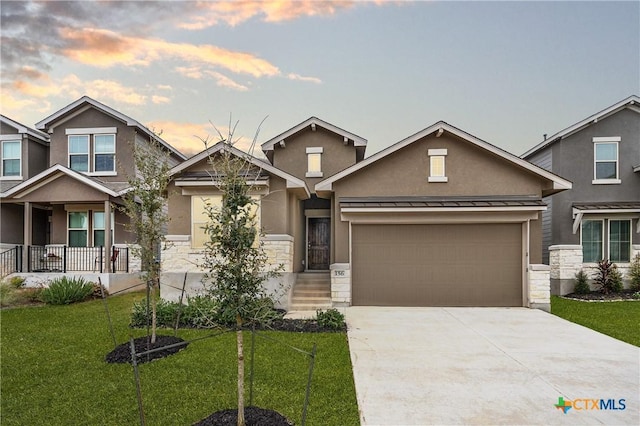 craftsman house with a garage and a yard