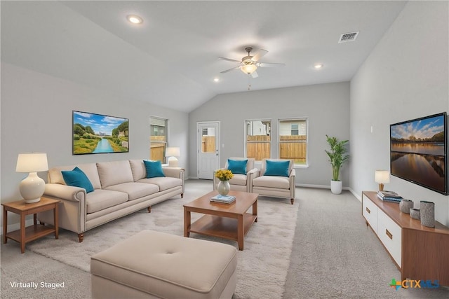 carpeted living room with ceiling fan and vaulted ceiling