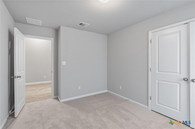 unfurnished bedroom with light colored carpet