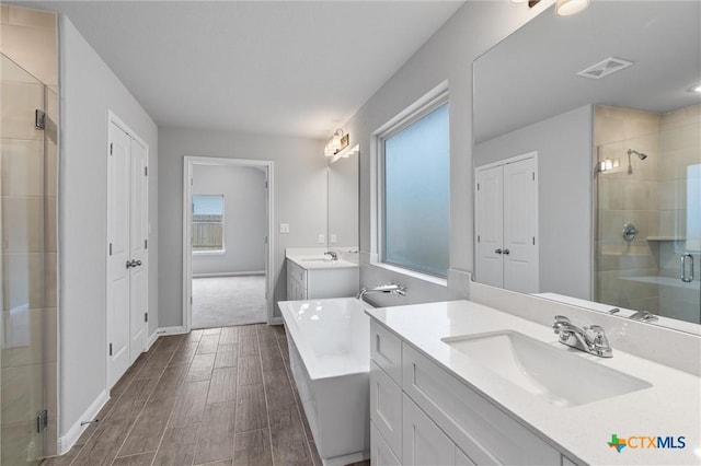 bathroom featuring plus walk in shower and vanity