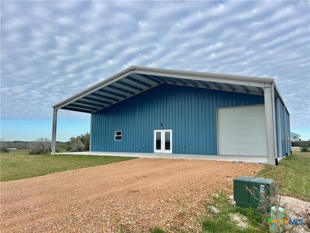 view of outdoor structure with a garage and a lawn