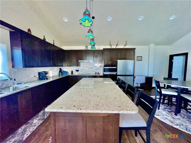 kitchen featuring dark hardwood / wood-style floors, sink, and a kitchen island