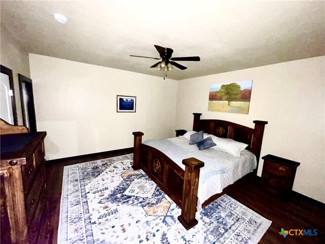 bedroom featuring dark hardwood / wood-style flooring and ceiling fan