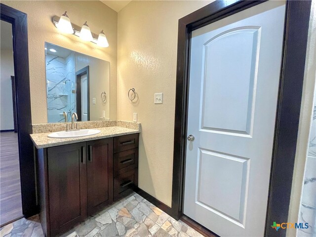 bathroom with vanity and hardwood / wood-style floors