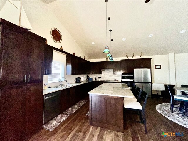 kitchen featuring sink, black appliances, vaulted ceiling, a center island, and dark hardwood / wood-style flooring