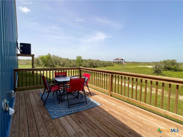 wooden terrace with a yard