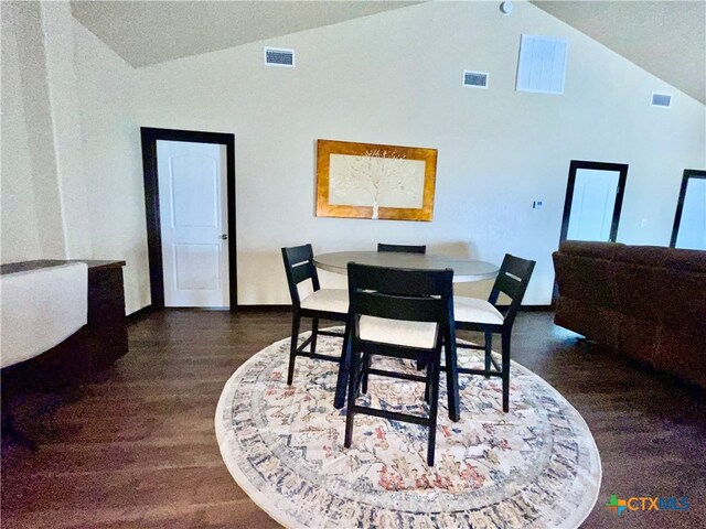 dining area with lofted ceiling and dark wood-type flooring